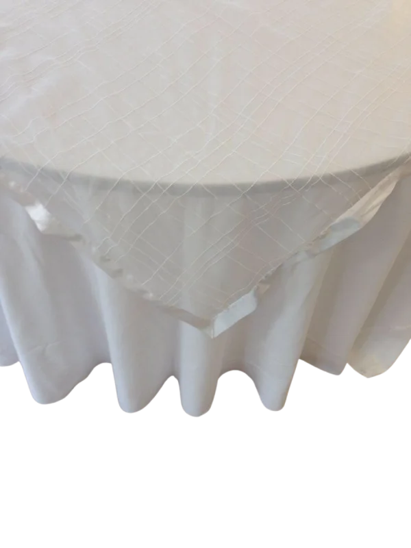 White organza table overlay with checkered embroidery and satin trim